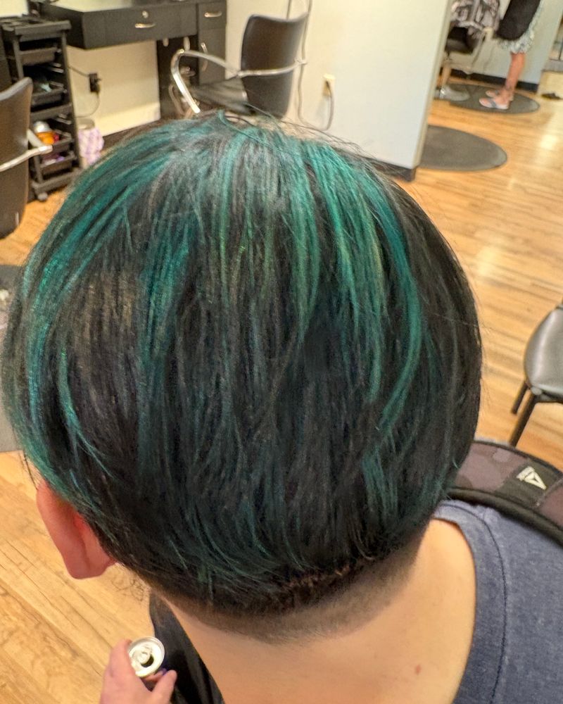 Dark hair with teal color and an undercut